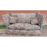 A large knoll two-seater sofa, upholstered in multicoloured floral pattern tapestry material with