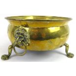 A Victorian twin lion mask handled brass planter. The jardinière of shallow cauldron form applied