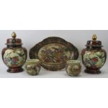 A group of Japanese satsuma items, 20th century. Comprising a pair of vases with covers, a pair of