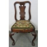 An antique occasional chair in the manner of George II, with shaped back splat and drop-in