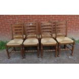 A set of eight vintage oak Lancashire ladder-back dining chairs with rush seats, on turned