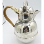 A large silver Guernsey jug with wicker handle, London 1948, engraved shield. Approx 8"/20cm high,