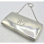A silver rectangular purse on a chain, Birmingham 1912, monogrammed, with green silk liner. Approx