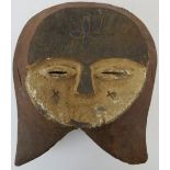 Tribal Art: An African carved wood mask, Kwele people, Gabon/Congo. Carved wood decorated with