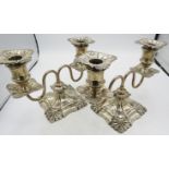 A pair of Victorian double branch silver candelabrum, with square bases and embossed decoration,