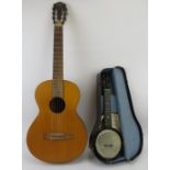 A guitar and uke-i-tar, 20th century. The uki-I-tar with original travel case. (2 items) Guitar: