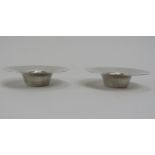 A pair of sterling silver candlesticks designed by the renowned Danish designer Nanna Ditzel and