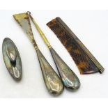 A silver nail buffer, a silver backed comb and a pair of silver handles buttons hooks & shoe horn.