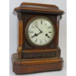 A Victorian mahogany table clock, 19th century. With enamelled Roman numeral dial and supported on
