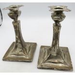 A pair of silver Arts & Crafts candlesticks, hallmarks worn, c. 1906. Approx 6" (15cm) long,