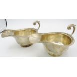 A pair of silver sauce boats with double scroll acanthus leaf handles and pedestal foot, Chester