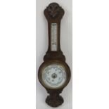 A carved oak aneroid barometer, late 19th/early 20th century. Incorporated with a mercury