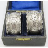 A pair of embossed silver napkin rings, Birmingham hallmarks worn, boxed. Approx weight 1.1 troy