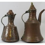 Two Middle Eastern metalwork decanters. Comprising a copper jug of mallet form with hinged cover