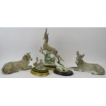 A group of five Lladro figurines. Comprising a leaping gazelle, recumbent bull, recumbent donkey,