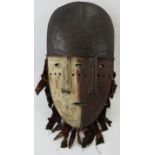 Tribal Art: An African Janus carved wood mask, Lega People, Congo. Carved wood and polychrome
