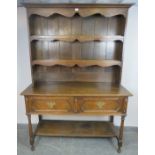 A 19th century oak Welsh dresser in the 18th century taste, the plate rack shelving with shaped