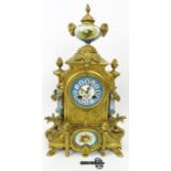 A French ormolu and porcelain mantle clock, 19th century. Modelled in the Neoclassical style with