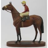 A large Beswick connoisseur model of Red Rum. Modelled on a wooden base inscribed ’Red Rum Brian