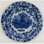A Dutch Delft blue and white charger, 18th century. Painted with a basket of flowers to the centre