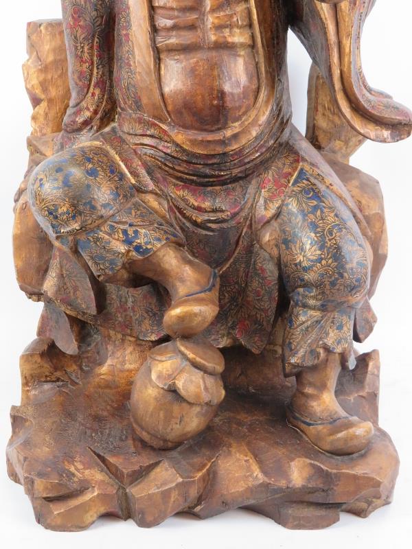 A Chinese gilt and lacquer painted carved wood figure of an immortal, 20th century. Depicted - Image 3 of 6