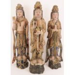Three Chinese gilt and lacquer painted carved wood figural interpretations of Guanyin, 20th century.