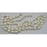 A large fresh water pearl necklace interspersed with white metal beads and having a white metal ball