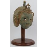 A decorative Oriental bronze helmet, probably 20th century. Partially gilt with verdigris. 16.5
