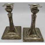 A pair of silver Arts & Crafts candlesticks, hallmarks worn, c. 1906. Approx 6" (15cm) long,