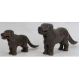 Two vintage novelty cast iron nut crackers modelled as dog hounds. Both tails with leaver