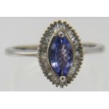 AAA grade faceted marquee cut tanzanite with halo set tapered baguette diamonds, overall portrait