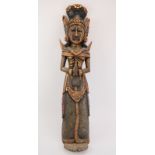 An Oriental gilt and painted carved wood Buddhist statue of a female figure. Depicted wearing