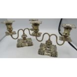 A pair of Victorian double branch silver candelabrum, with square bases and embossed decoration,