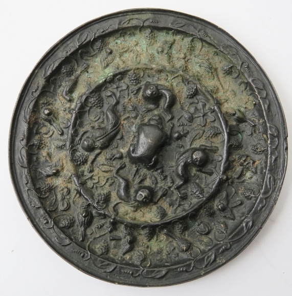 Two Chinese bronze mirrors. In the Tang dynasty style with decoration cast in relief depicting a - Image 2 of 5