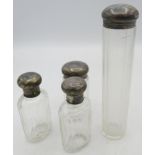 A collection of four panel cut travelling jars with silver tops, London 1909 & 1910. Condition