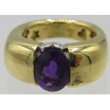 A heavy 18ct yellow gold ring set with centre amethyst, approx 10mm x 8mm. To the top of the ring is