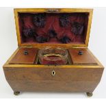 A late Georgian rosewood tea caddy. Of sarcophagus form with twin handles, three internal