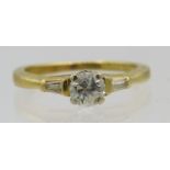 An 18ctyellow gold diamond set ring, the centre diamond approx 0.5cts and baguette shoulders