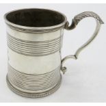 A Georgian silver christening mug with double scroll acanthus leaf handle, monogrammed. Approx 3"/