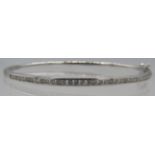 An 18ct white gold bangle with one half set with a band of diamonds. Diamonds approx 1ct, double