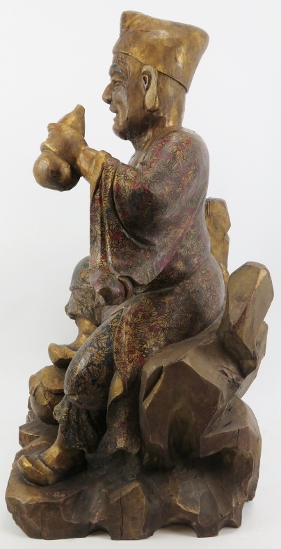 A Chinese gilt and lacquer painted carved wood figure of an immortal, 20th century. Depicted - Image 4 of 6