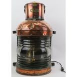 A large vintage Norie & Wilson copper and brass ship’s lamp. Modelled with a swing handle and