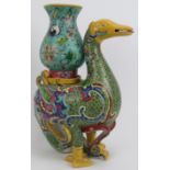 A large Chinese polychrome enamelled porcelain duck, 20th century. Modelled as a duck carrying a
