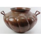 A large European Arts & Crafts style planished copper cauldron, 20th century. Modelled with a
