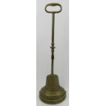 A Victorian brass bell shaped doorstop. Modelled with a stepped lead weighted base. 16 in (40.7
