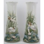 A pair of European vases, late 19th/early 20th century. Both decorated in relief with riverside