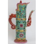 An unusual Chinese famille rose enamelled hot water decanter and cover. The spout modelled with an
