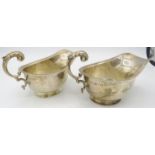 A pair of silver sauce boats with double scroll acanthus leaf handles and pedestal foot, Chester