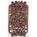 A Chinese carved wood panel, 20th century. Carved in openwork with a central figural roundel. 23