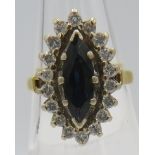 An 18ct yellow gold marquise sapphire & diamond ring, sapphire approx 12mm x 4mm, surrounded by 18
